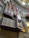 Vertical metallic pipe organ mounted on the wall